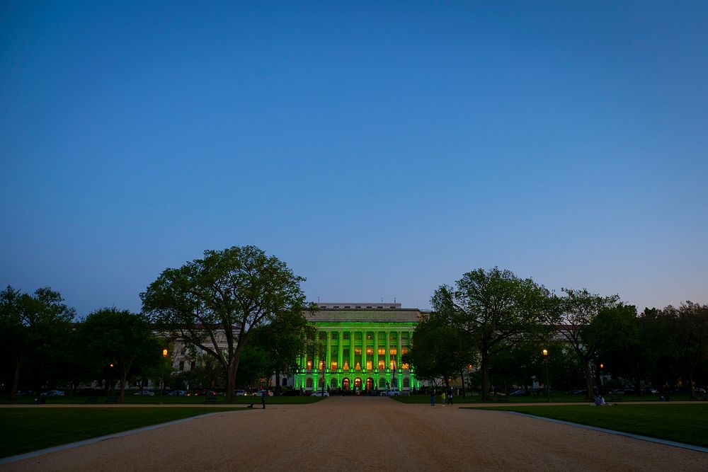 Green lights illuminate the USDA’s Jamie L. Whitten Building in Washington, DC, April 19, 2021 and will remain lit until…