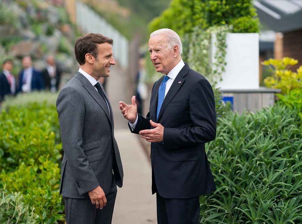 President Joe Biden and French President Emmanuel Macron talk prior to the first session of the G7 Summit on Friday, June…