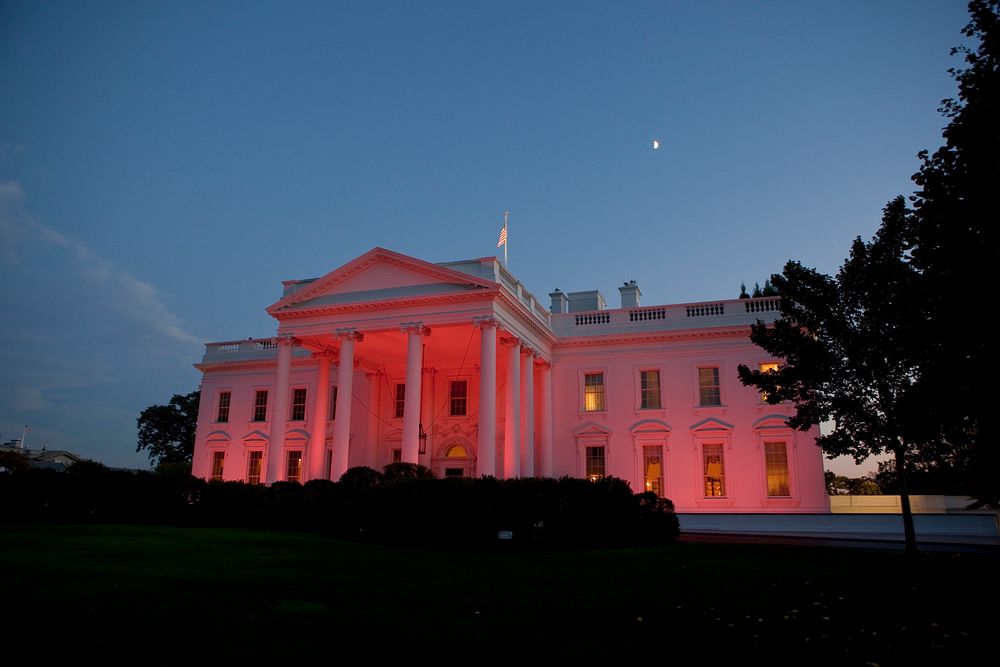 The White House, seen from the North Grounds, is bathed in pink light in honor of Breast Cancer Awareness Month, Oct. 14…