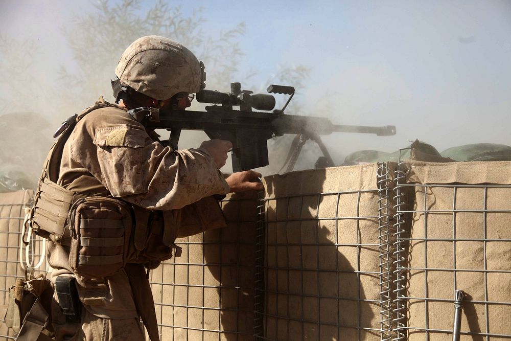 U.S. Marine Corps Sgt. Corey Sherwood provides cover fire for Marines assigned to an explosive ordinance disposal unit in…