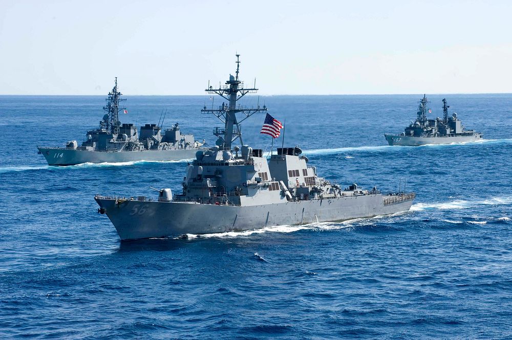 The USS John S. McCain (DDG-56), an Arleigh Burke-class destroyer, joins a combined formation of twenty-six Japan Maritime…