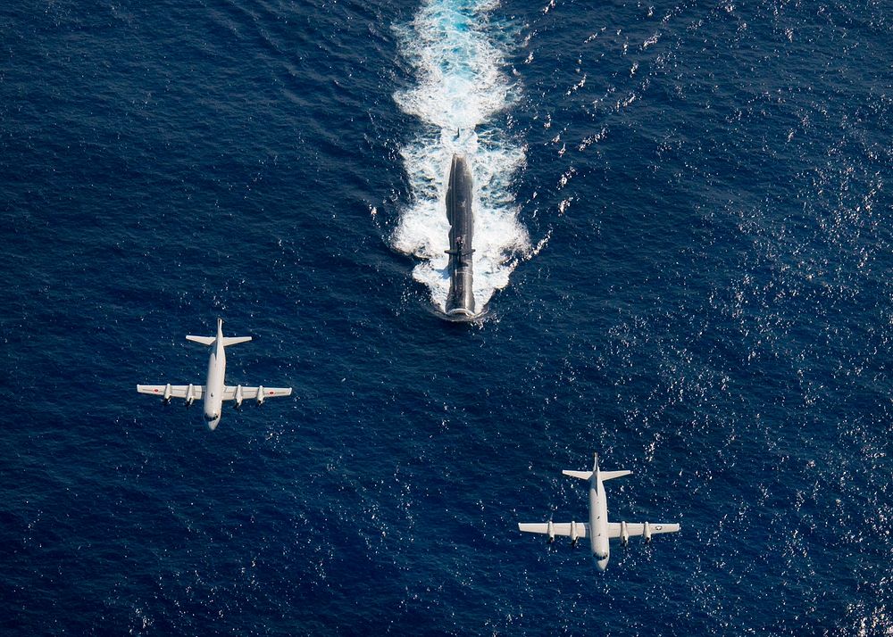 Two P-3 Orion anti-submarine and maritime surveillance aircraft from the Japan Maritime Defense Force, left, and the U.S.…