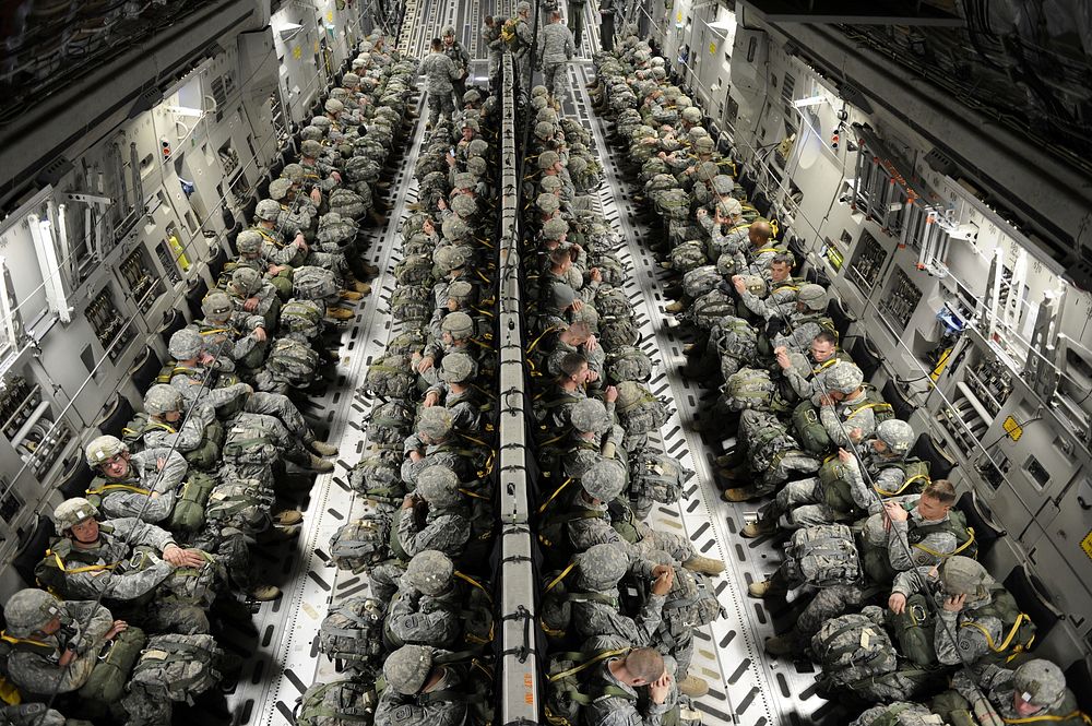 U.S. Army paratroopers with the 82nd Airborne Division sit in an Air Force C-17A Globemaster III before an airdrop during a…