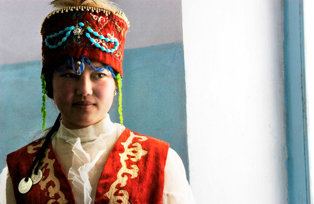 A local woman in her traditional attire and headpiece,. Original public domain image from Flickr