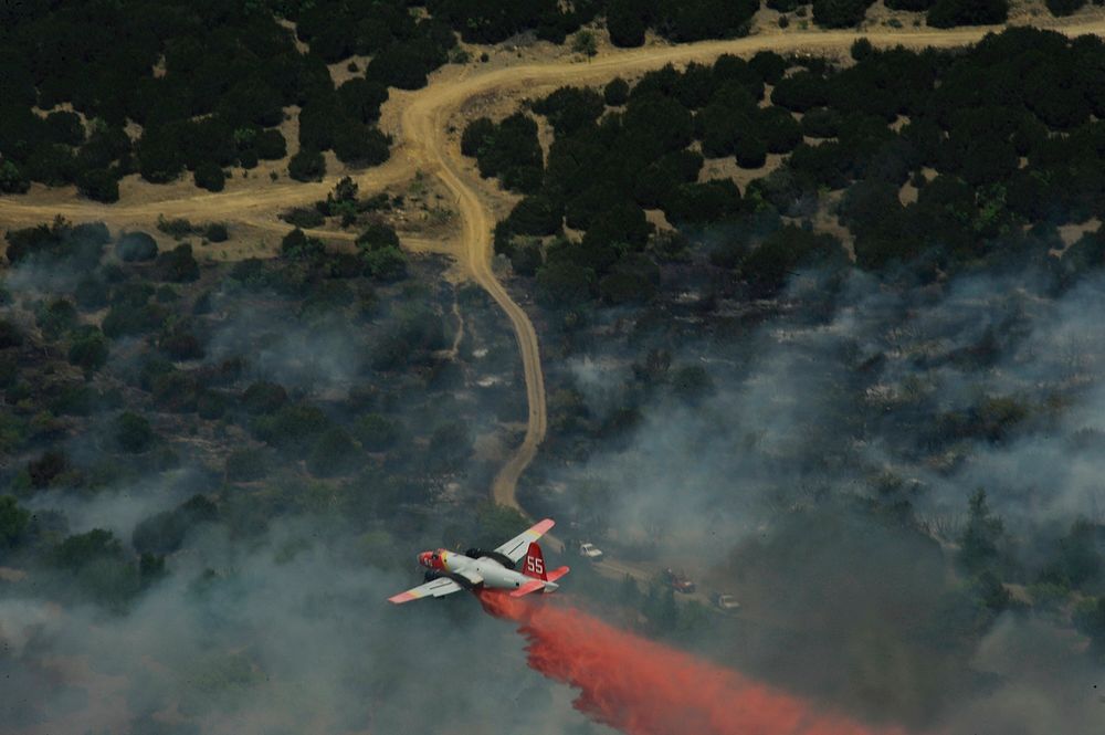 A Minden Air Lockheed SP-2H Neptune tanker drops flame retardant in Texas April 19, 2011, as wildfires burn across the state.