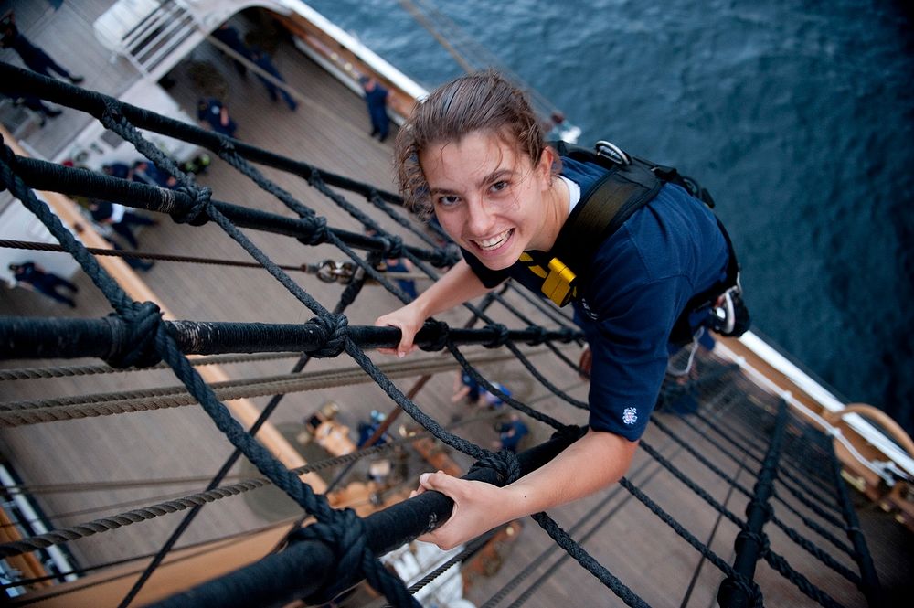U.S. Coast Guard Fourth Class Cadet Kelsey Hickle poses for a photo while climbing the rigging aboard the Coast Guard Cutter…