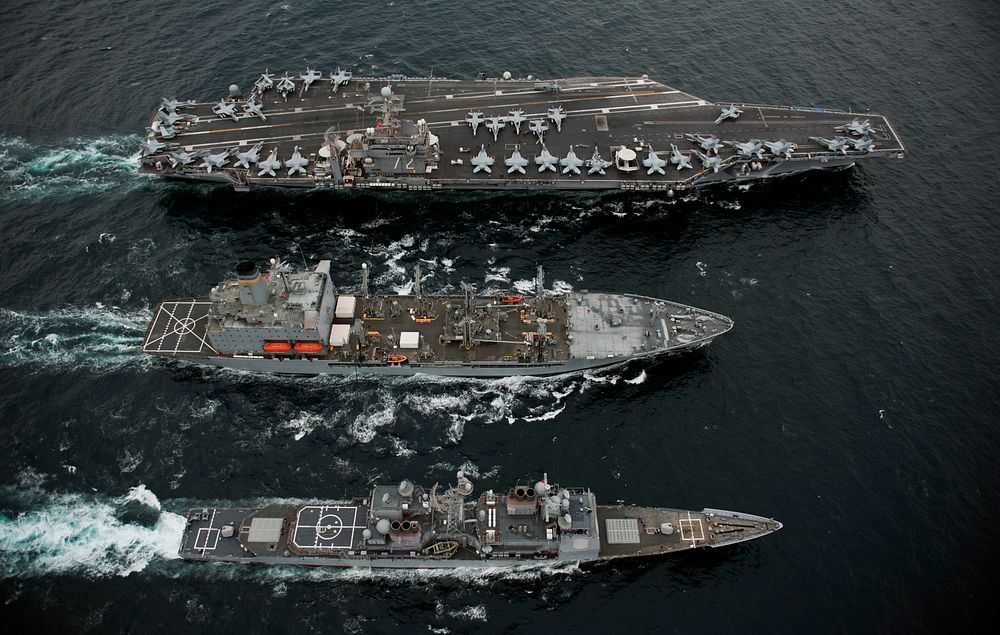 From top, the aircraft carrier USS Abraham Lincoln (CVN 72), the fleet replenishment oiler USNS Guadalupe (T-AO 200) and the…