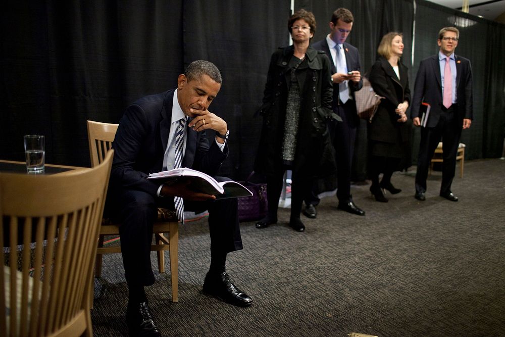 President Barack Obama waits with staff backstage before an event at the Pepsi Center in Denver, Colo., Oct. 25, 2011.