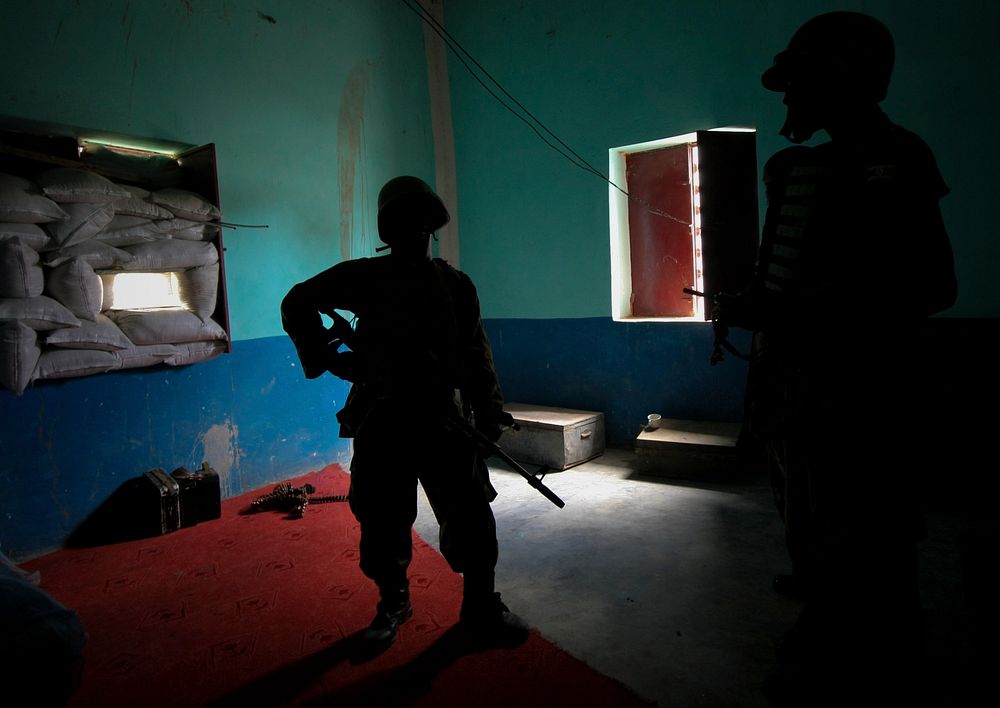 Ugandan soldiers serving with the African Union Mission in Somalia (AMISOM) 33rd Battalion stand inside an abandoned house .…