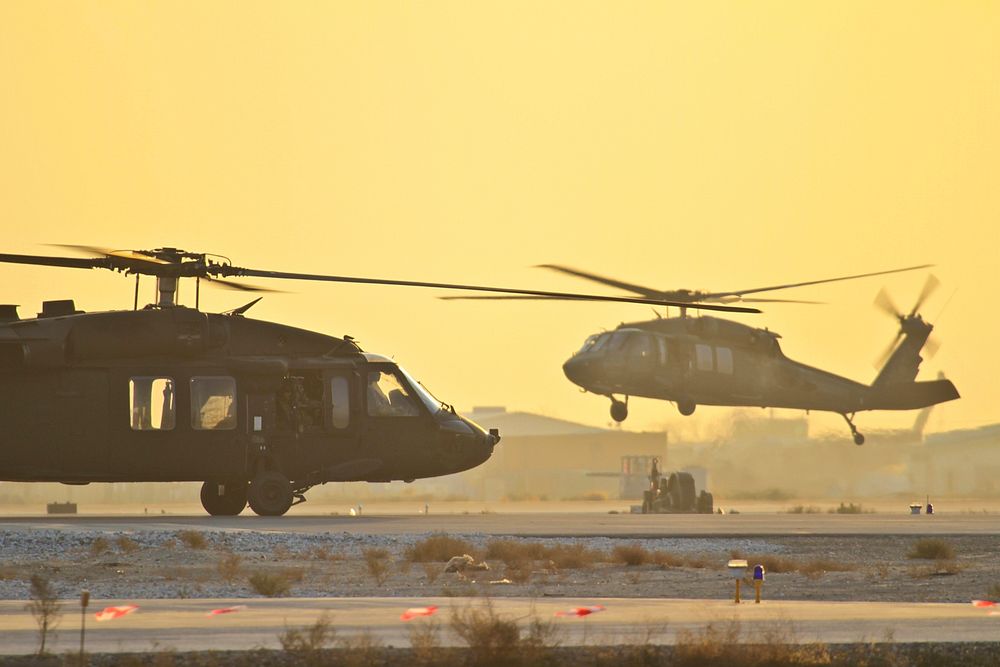Two U.S. Army UH-60 Black Hawk helicopters prepares for takeoff at Bagram Air Field, Afghanistan, Dec. 4, 2011. Original…