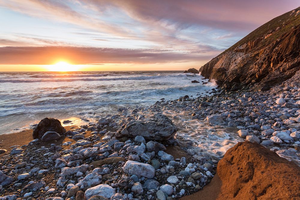 Sunset on the beach shore. Free public domain CC0 photo.