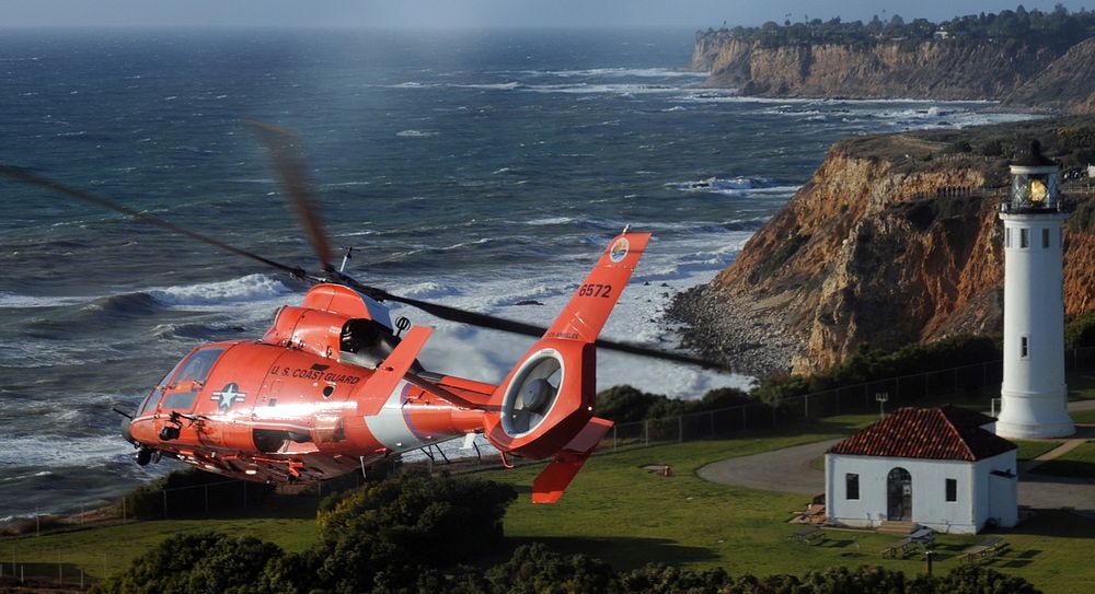 A U.S. Coast Guard MH-65C Dolphin helicopter crew assigned to Air Station Los Angeles conducts a flyover of the Point…