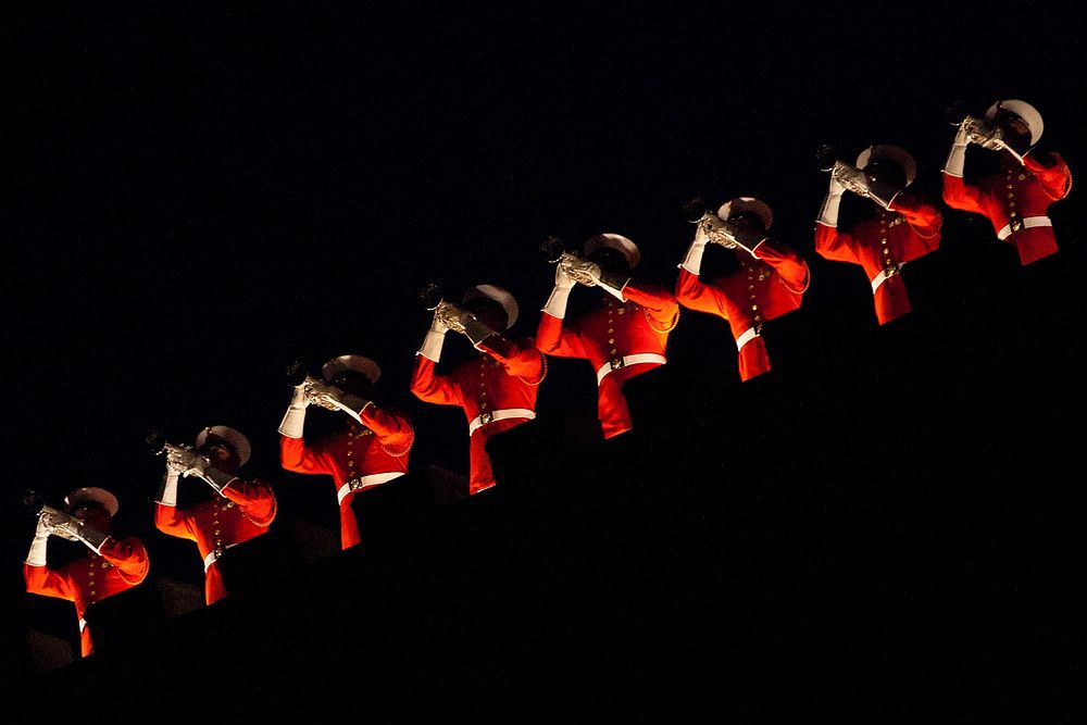 The U.S. Marine Corps Drum and Bugle Corps buglers perform during the Friday Evening Parade at the Marine barracks in…