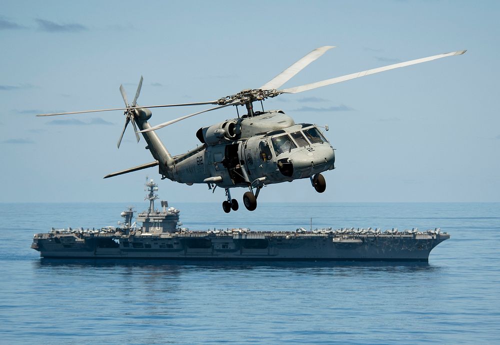 An SH-60F Sea Hawk helicopter assigned to Helicopter Anti-Submarine Squadron (HS) 15 flies past the Nimitz-class aircraft…