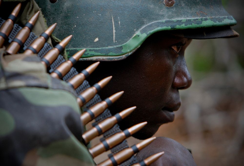 A soldier serving with the African Union Mission in Somalia (AMISOM) takes up a defensive position during a firefight 22…