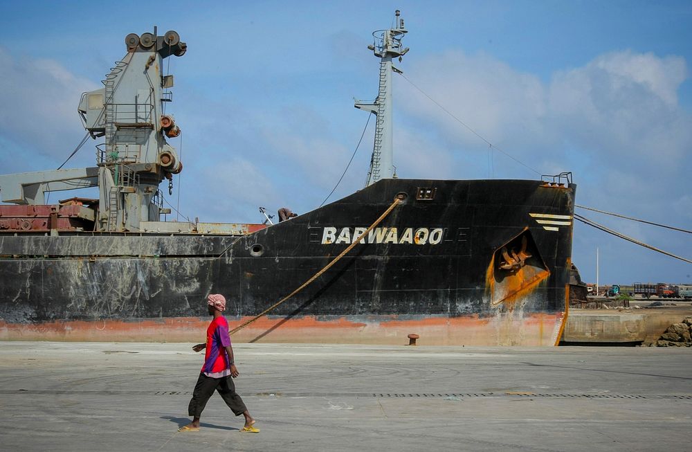 A dock worker walks past a ship 06 August 2012, inside the seaport of the Somali capital Mogadishu.