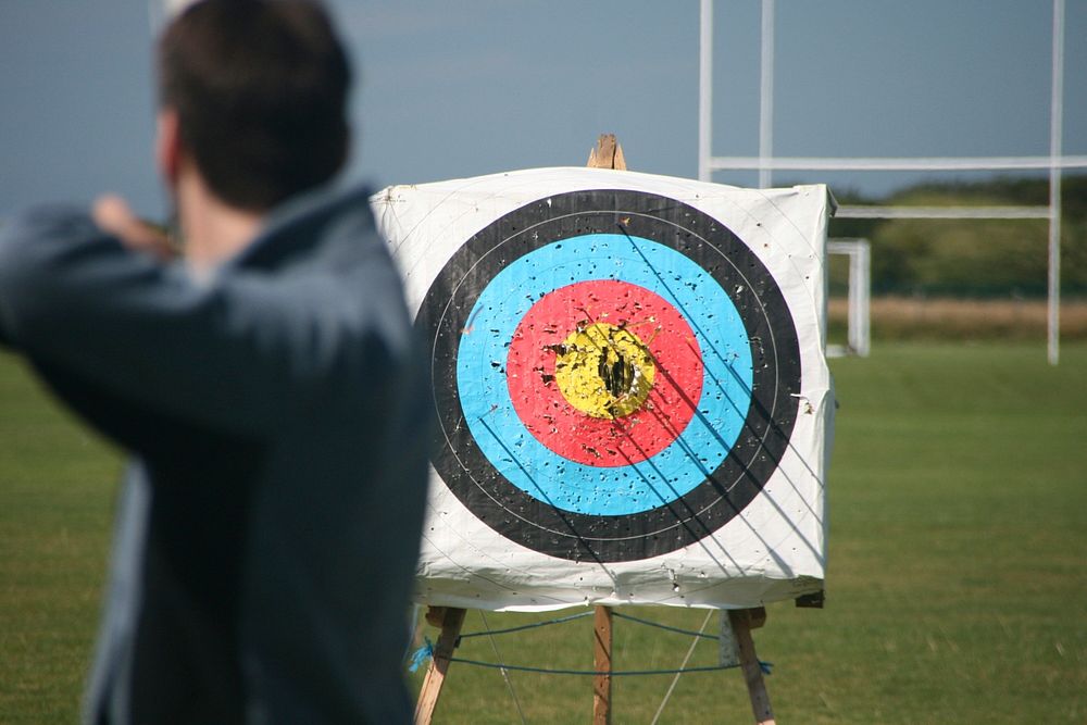 Man archer hitting the target, archery sport. Original public domain image from Flickr