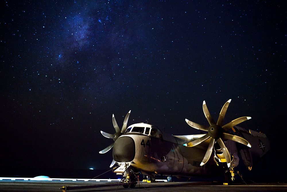 A U.S. Navy C-2A Greyhound aircraft assigned to Fleet Logistics Support Squadron (VRC) 40 sits on the flight deck of the…