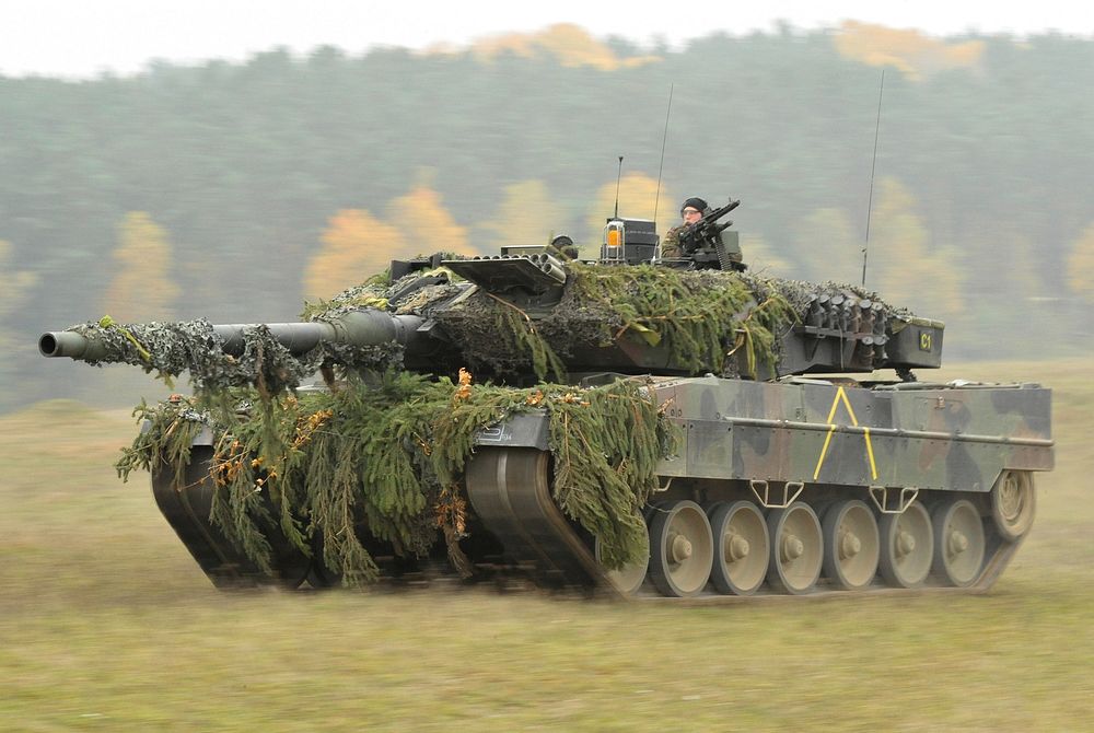 RollingA German Army Leopard II tank, assigned to 104th Panzer Battalion, moves through the Joint Multinational Readiness…