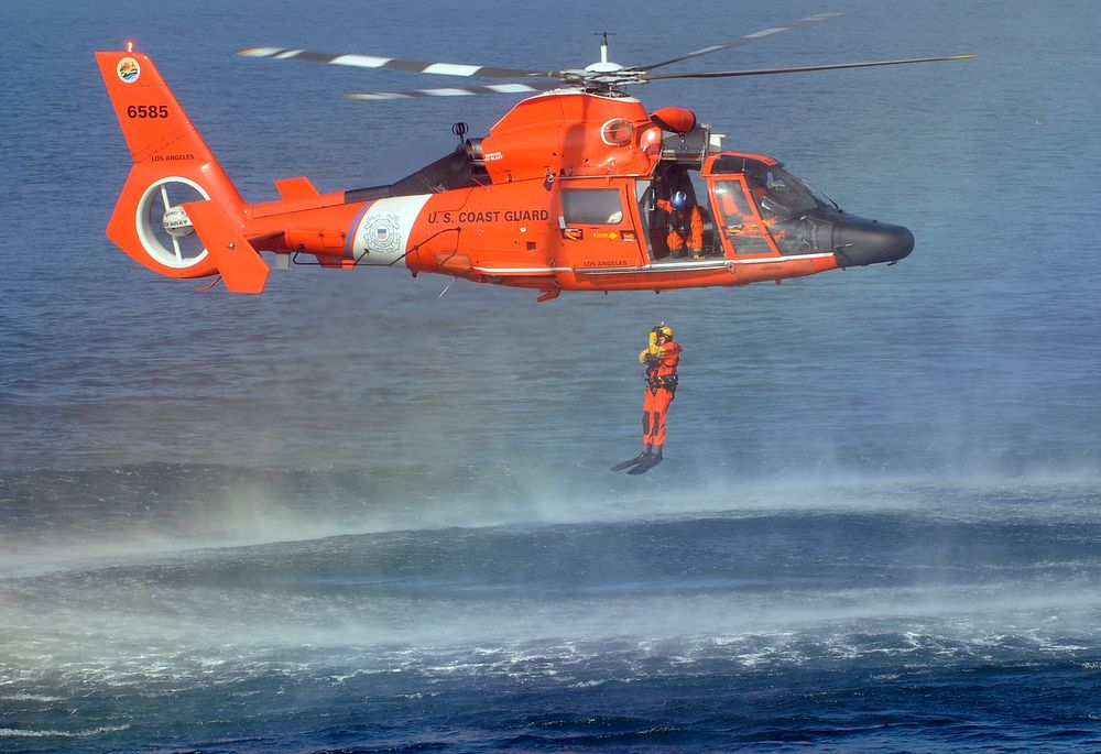 U.S. Coast Guard Petty Officer 1st Class Ty Aweau, an Aviation Survival Technician, conducts rescue swimmer training with an…