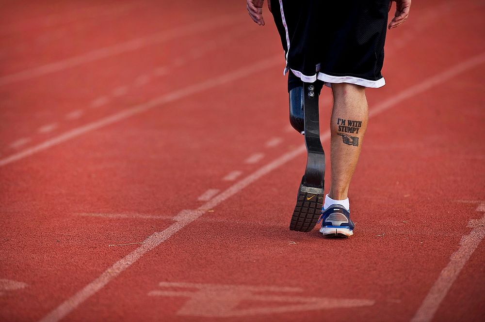 U.S. Navy Petty Officer 3rd Class Redmond Ramos walks on a track during the first Wounded Warrior Pacific Trials at Joint…