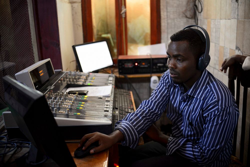 A studio technician at Radio Shabelle works to prepare a show for broadcast. AU-UN IST PHOTO / TOBIN JONES. Original public…