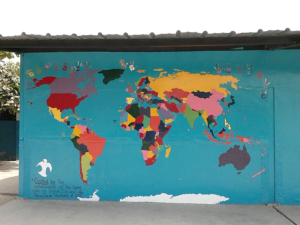 Colorful world map on blue wall. Original public domain image from Flickr