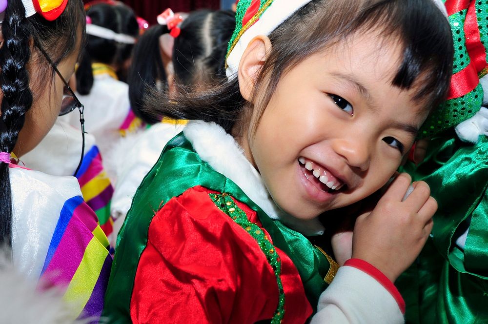 A child smiles at U.S. Airmen during an orphanage visit in South Korea, Dec. 22, 2012.