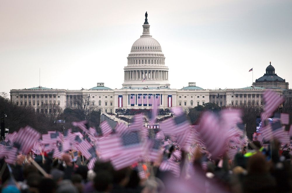 Attendees wave flags at the National Mall during the 57th presidential inauguration in Washington, D.C., Jan. 21, 2013.