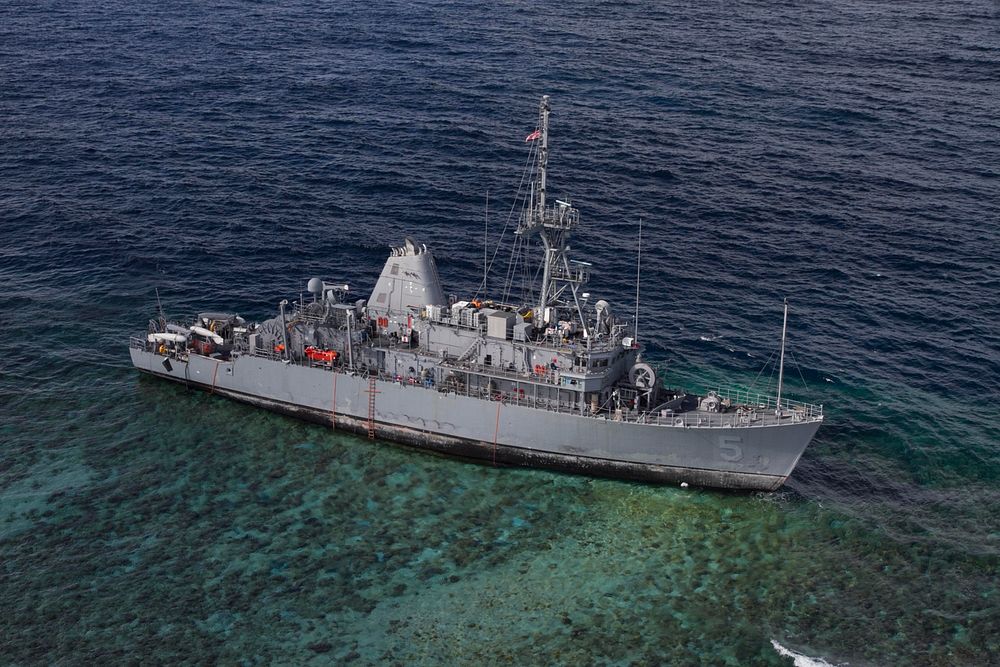 The mine countermeasures ship USS Guardian (MCM 5) sits aground on the Tubbataha Reef in the Sulu Sea, western Philippines…