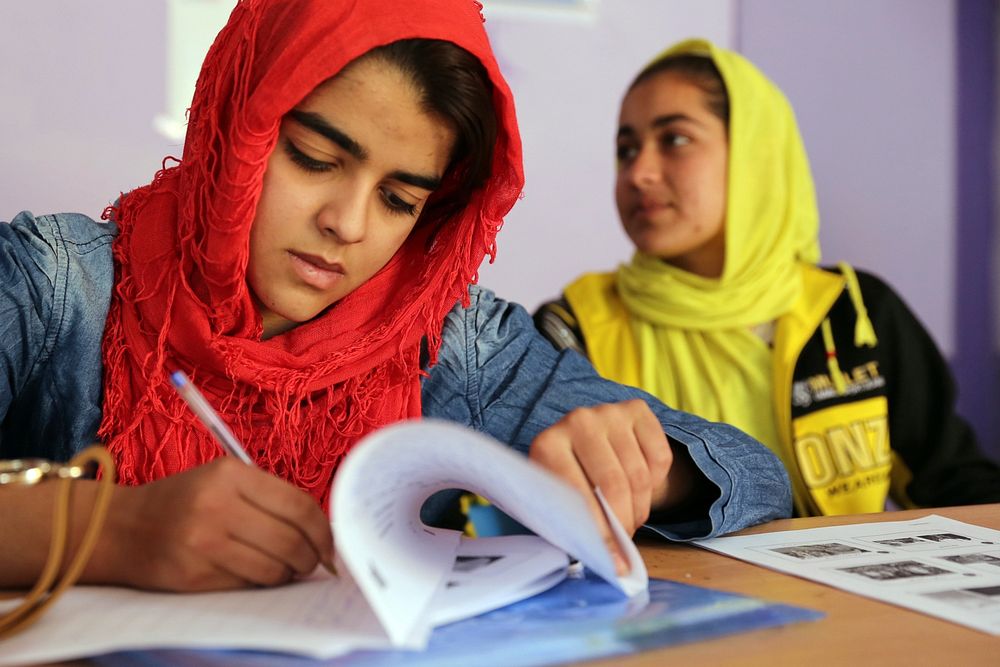 An Afghan journalist signs an attendance roster during photojournalism training in Farah, Afghanistan, Feb. 10, 2013.