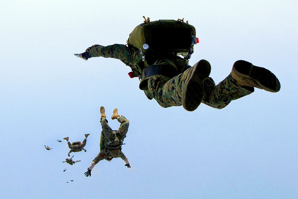 Into the Wild Blue. Marines jump out of the back of a KC-130J Hercules while conducting aerial delivery training during…