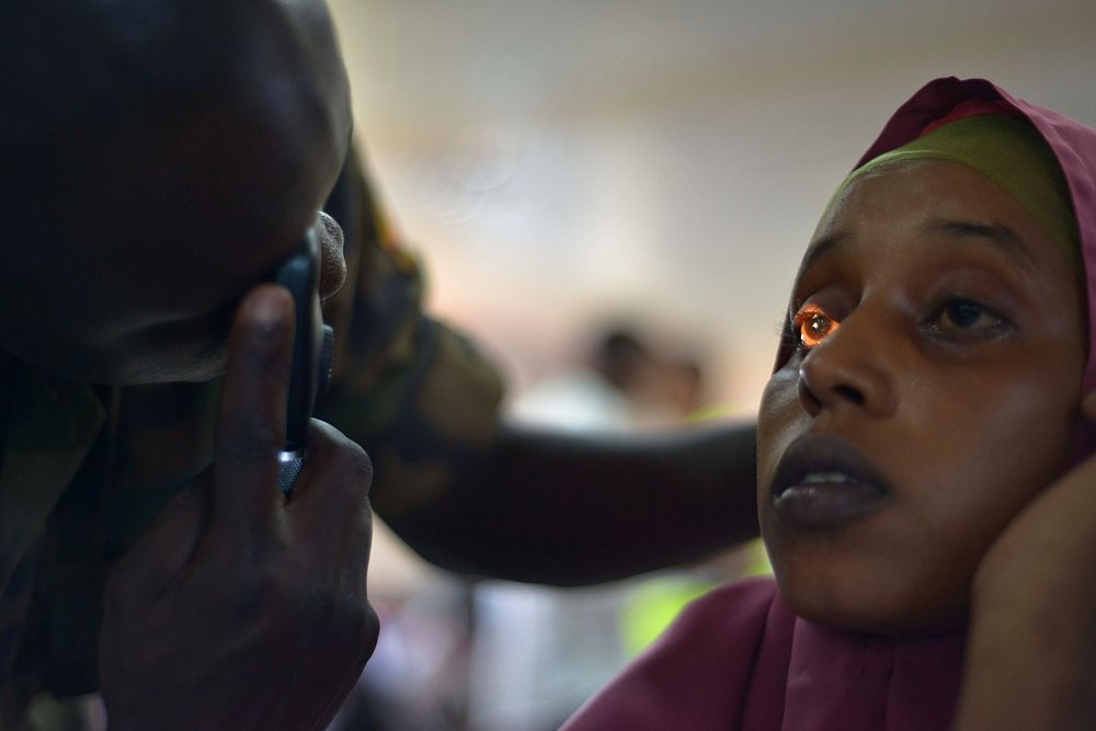 An army medic checks a patient's eyes at a medical outreach centre in the Somali capital Mogadishu as part of the Tarehe…