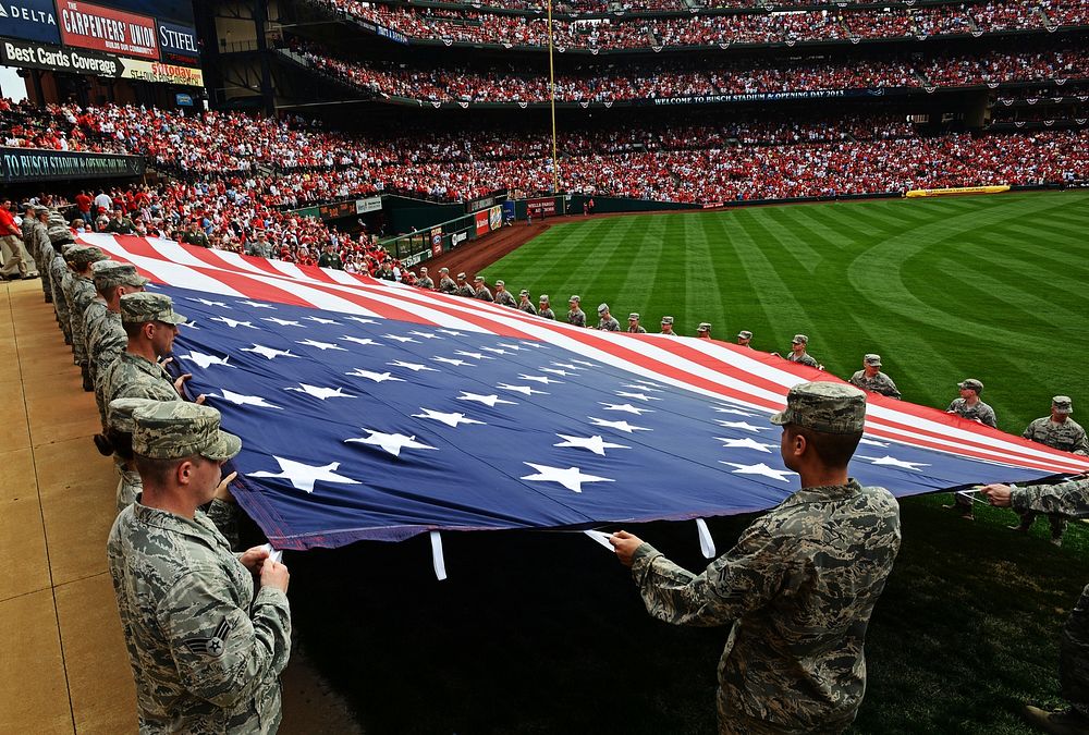 U.S. Airmen with the 375th Air Mobility Wing present a giant U.S. flag for nearly 50,000 fans to see at Busch Stadium in St.…