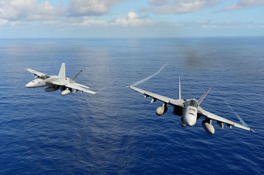 Two U.S. Navy F/A-18E Super Hornet aircraft assigned to Strike Fighter Squadron (VFA) 14 participate in an air power…