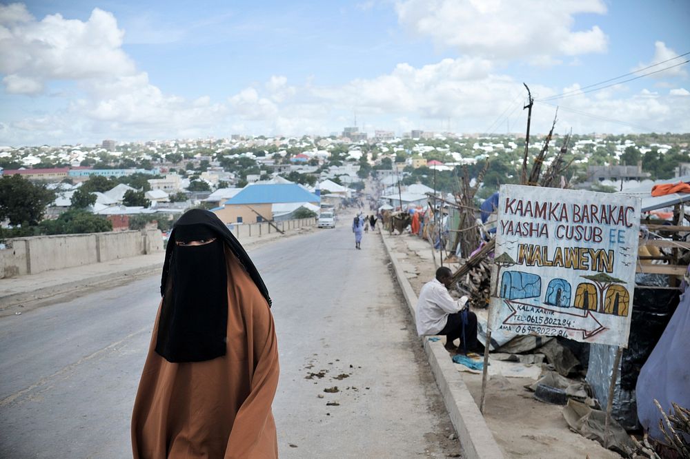 A woman walks past an IDP camp in Mogadishu, Somalia, on May 3rd.