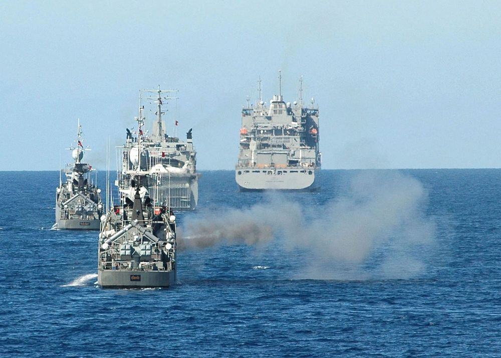 The Royal Thai Navy corvette HTMS Sukhothai (FSGM 442), second from left, fires at a BQM-74 target drone during a live-fire…