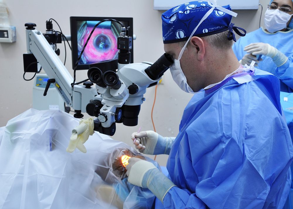 U.S. Air Force Maj. Matthew Caldwell, foreground right, a cornea and refractive surgeon with the 59th Medical Wing, performs…