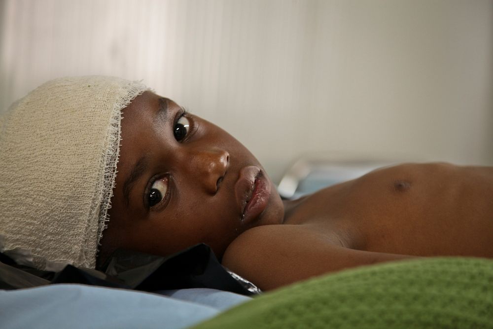 A young boy lies in the AMISOM Level II hospital on July 8 after having been wounded during fighting in Kismayo, Somalia. AU…