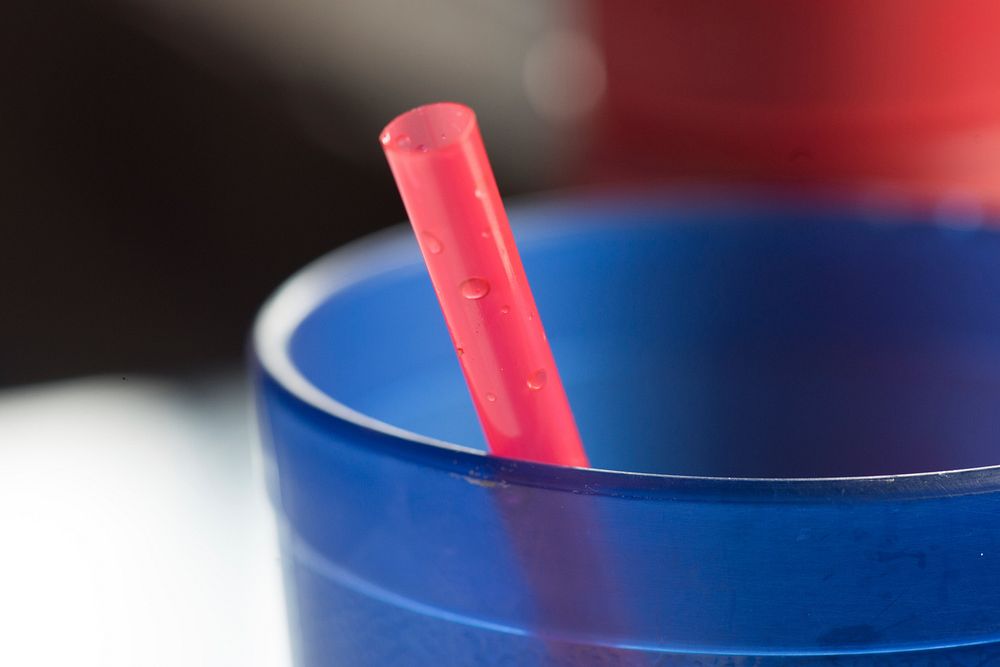 Red straw in a blue cup. Free public domain CC0 photo