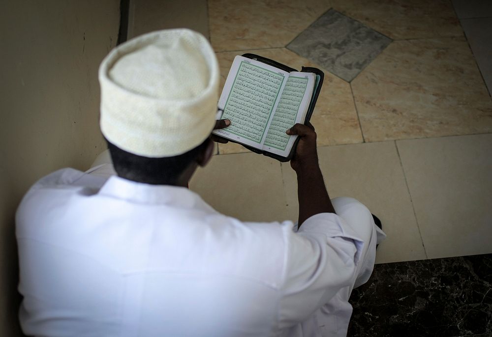 A delegate reads the Koran. Original public domain image from Flickr