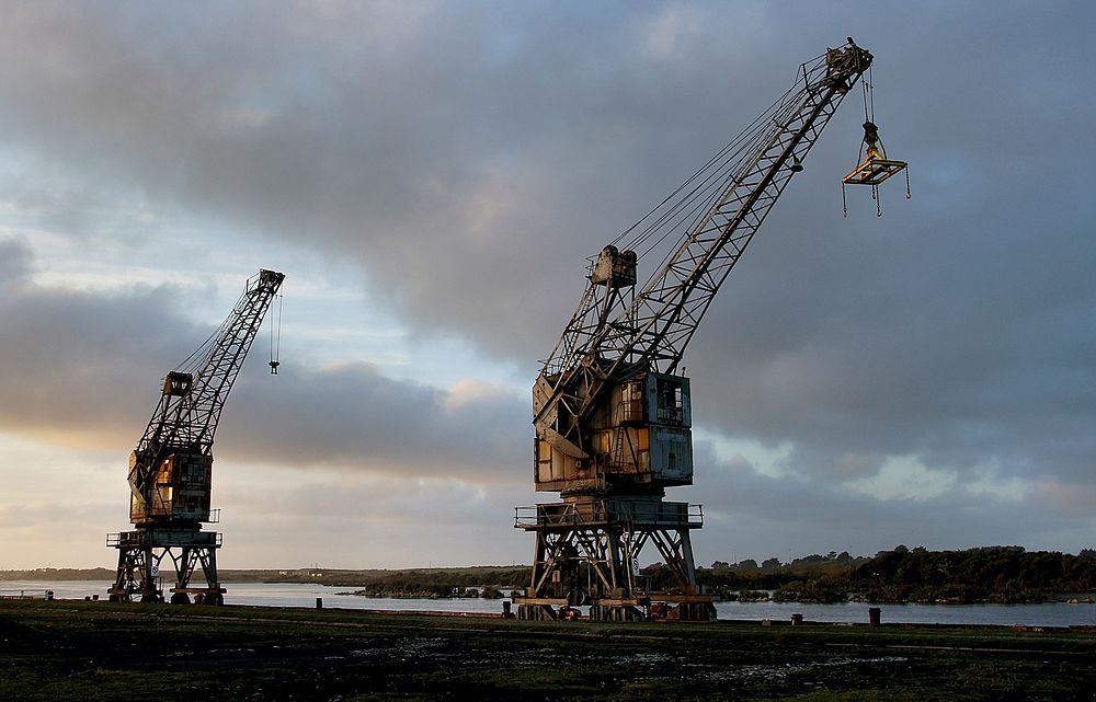 Dock side Derricks. Derelict wharf cranes, Greymouth New Zealand. Original public domain image from Flickr