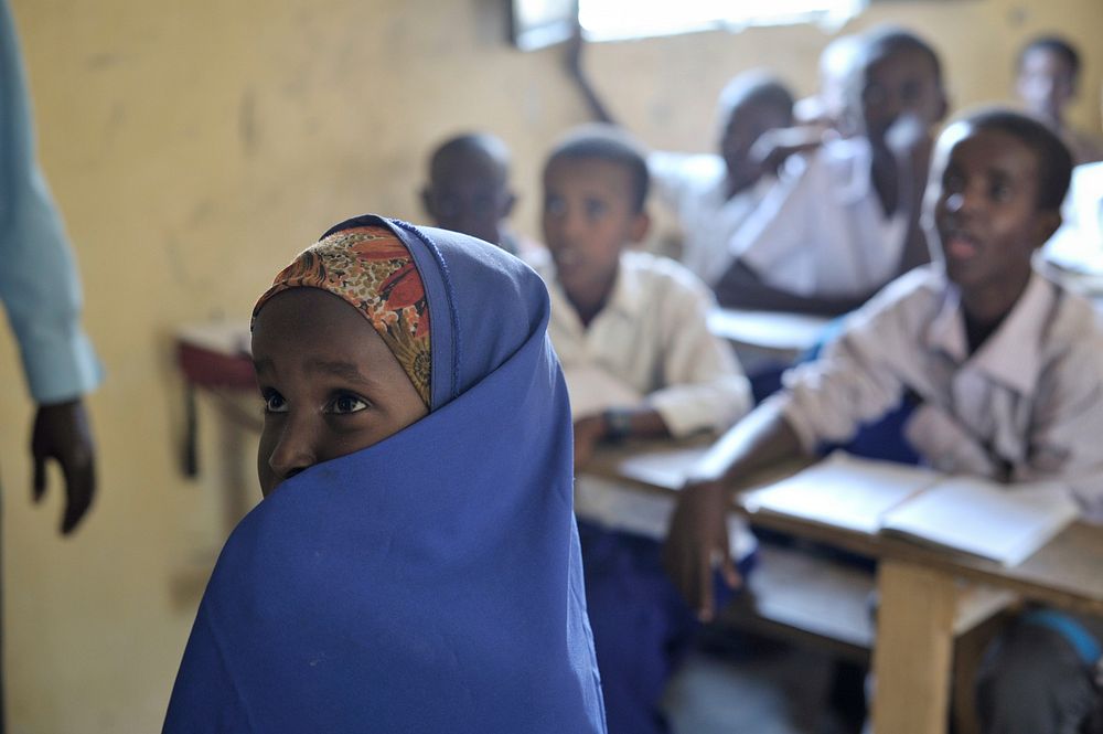 A Somali girl reads from the board during English class at as school run by the Abdi Hawa Center in the Afgoye corridor on…