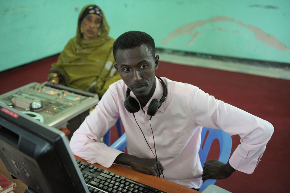 One of Radio Mogadishu's employees works a machine used to convert the archive's analog recordings into digital files on…