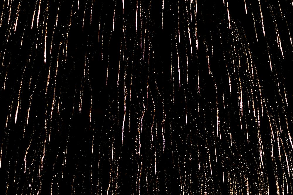Firework fragment, glitter on black background. Free public domain CC0 photo.