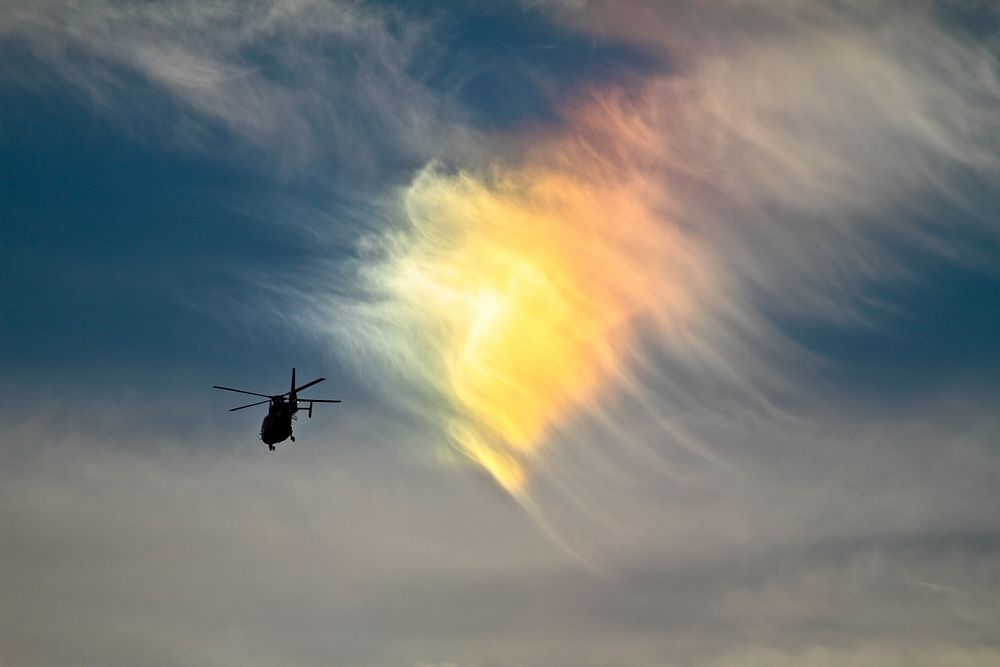 A U.S. Coast Guard HH-65C Dolphin rescue helicopter from Coast Guard Air Station Atlantic City flies near a circumhorizontal…