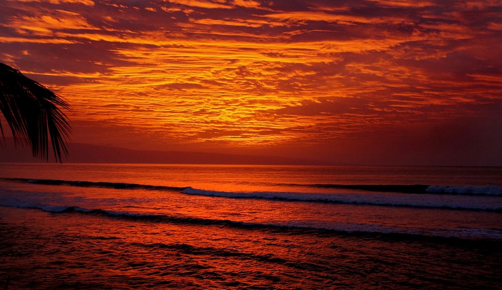 Sunset ocean, red sky, wavy beach. Original public domain image from Flickr