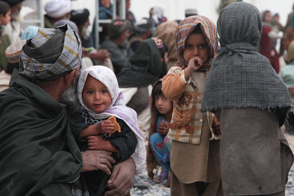 An Afghan family waits to receive care from Afghan National Army (ANA) medics at an ANA aid center in Panjwai district…