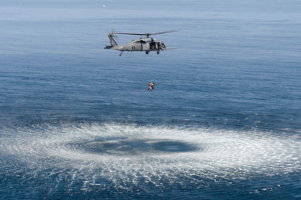U.S. Air Force pararescuemen with the 82nd Expeditionary Rescue Squadron (ERQS) are hoisted into an HH-60G Pave Hawk…