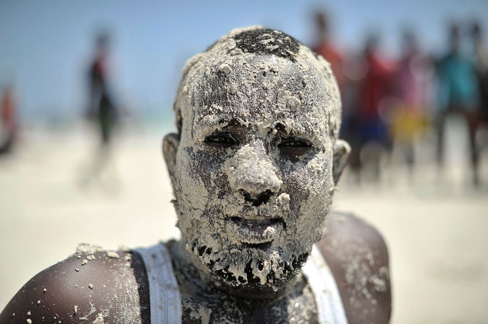 A Somali man, his face covered in sand, enjoys a day out at Lido beach in Mogadishu, Somalia, on January 31.